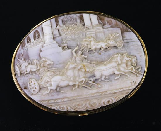 A large Victorian gold mounted oval cameo brooch, carved with scene of racing chariots, initialled T.V.